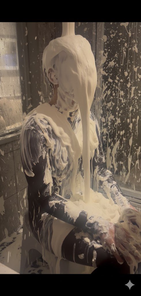 A lovely, white shaving foam gunging in the shower, fully clothed. 

#gunge #ai #gemini