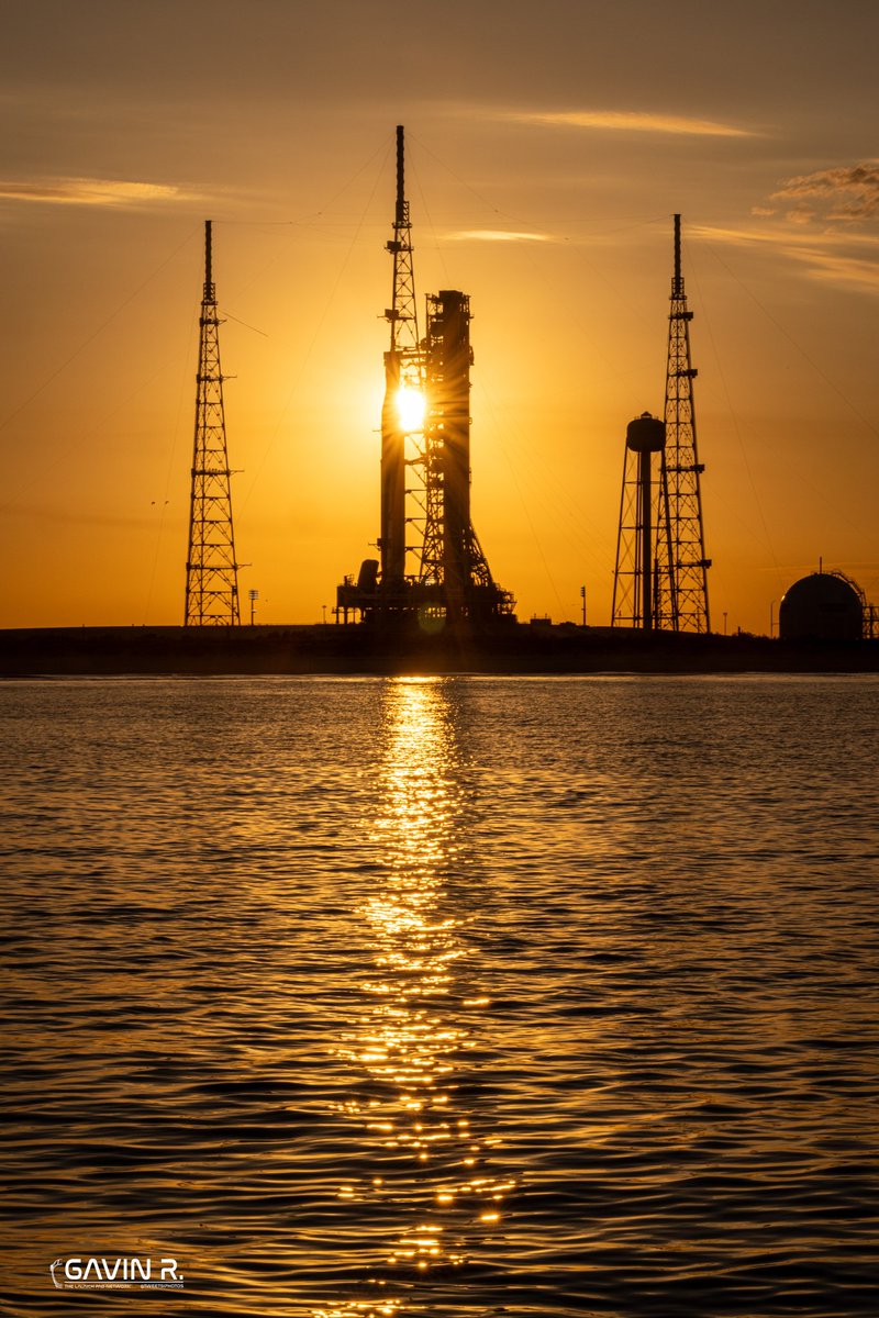 TheLaunchPadX's tweet photo. Golden hour on the Space Coast.  

NASA’s Space Launch System stands on LC-39B awaiting its next Wet Dress Rehearsal. This rocket will carry humans around the Moon for the first time since Apollo!

Hard to believe this isn’t a render…
It’s real, It’s happening, We are going back! 

📸: Gavin (@tweetsiphotos) for @TLPN_Official