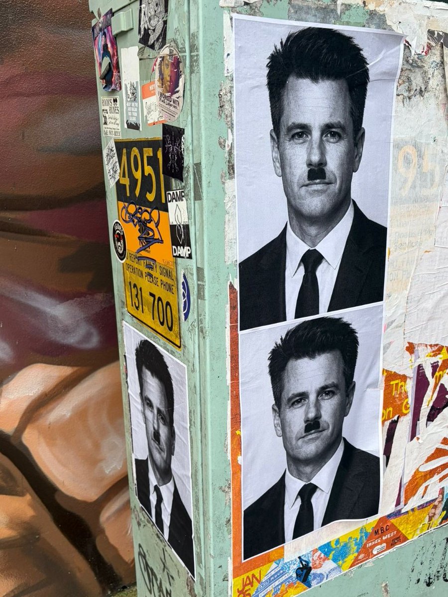 It's famously easy to draw a Hitler moustache on an image of the Premier of NSW, whoever that may be, digitally or otherwise. You don't need to use AI to do it. This looks like Matthew Perry.
