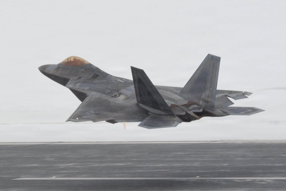 sentdefender's tweet photo. F-22 Raptors assigned to the U.S. Air Force’s 3rd Wing carry out flight operations during snowfall at Joint Base Elmendorf-Richardson in Alaska on February 10, 2026. https://t.co/gjvzp6xwzi