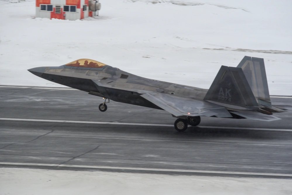 sentdefender's tweet photo. F-22 Raptors assigned to the U.S. Air Force’s 3rd Wing carry out flight operations during snowfall at Joint Base Elmendorf-Richardson in Alaska on February 10, 2026. https://t.co/gjvzp6xwzi