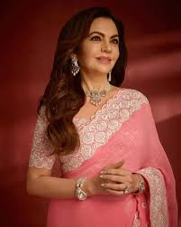 business_t14644's tweet photo. Nita Ambani looked stunning in a pink saree paired with her iconic diamond jewellery, while Radhika Merchant cheered for Kokila Ben in elegant white traditional wear. #NitaAmbani #RadhikaMerchant #StyleGoals #TraditionWithElegance #AmbaniFamily https://t.co/LP6fx3XPv3