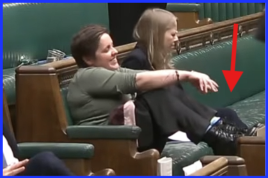 JR42845598's tweet image. What an absolute disgrace.  
Not only is this MP improperly dressed for a public role representing the UK on the world stage but she's underscoring her disrespect for the House by putting her feet on the benches and childishly chortling at another MP attempting to speak.