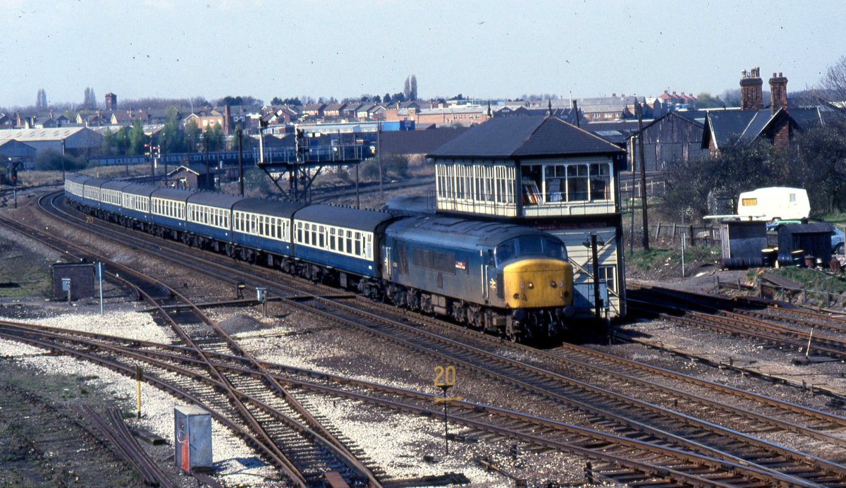 railexpress's tweet photo. From the Editor's archive:  With the recent visit of a 'Peak' to the Midland Main Line, here's No. 45104 The Royal Warwickshire Fusilier passing Wigston South signalbox in July 1982. https://t.co/PUnIBfb4kO
