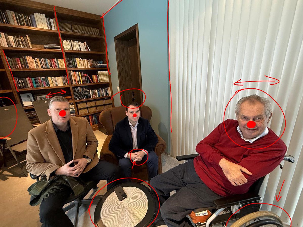 Celý tohle je AI
- Miloš vypadá, že je až moc vzhůru a střízlivej
- taky mu chybí kus kola, takže by se převrátil. Levitovat nemůže.
- místnost je celá nakřivo
- Číčovi chyběj nohy, takže by nemohl přijít 😂
- stolek je na křivo 
- místnost je nakřivo, lidi jsou málo nakřivo 
-