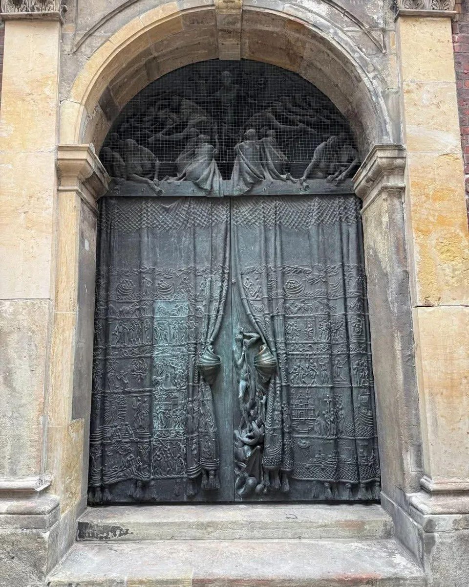 Doors that play peek-a-boo with their curtained panels.

St. Jacobi Church in Hamburg, Germany.