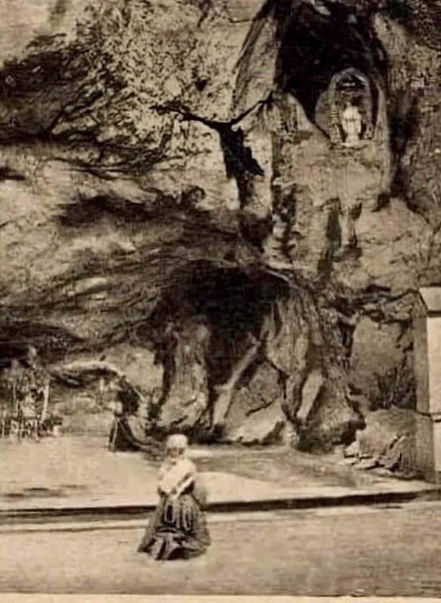 GrainneMcD92925's tweet image. Rare photo of Saint Bernadette Soubirous in Prayer in Front of the First Statue of the Virgin Mary in Lourdes, France.