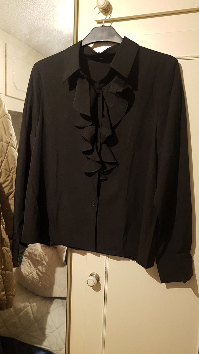 jeanmal1's tweet photo. Black slik blouse with ruffle down the front and a button front and has cuffs with button detail https://t.co/lEnkNxRnBP