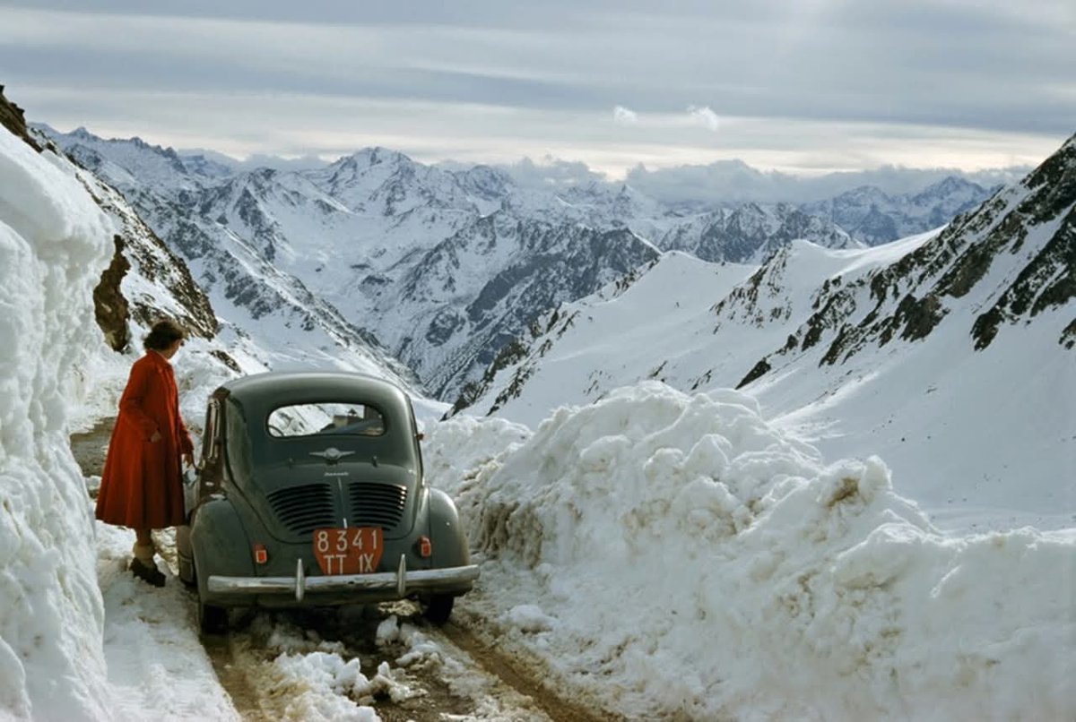 A woman stuck with her car in the Pyrenees of France, 1956.