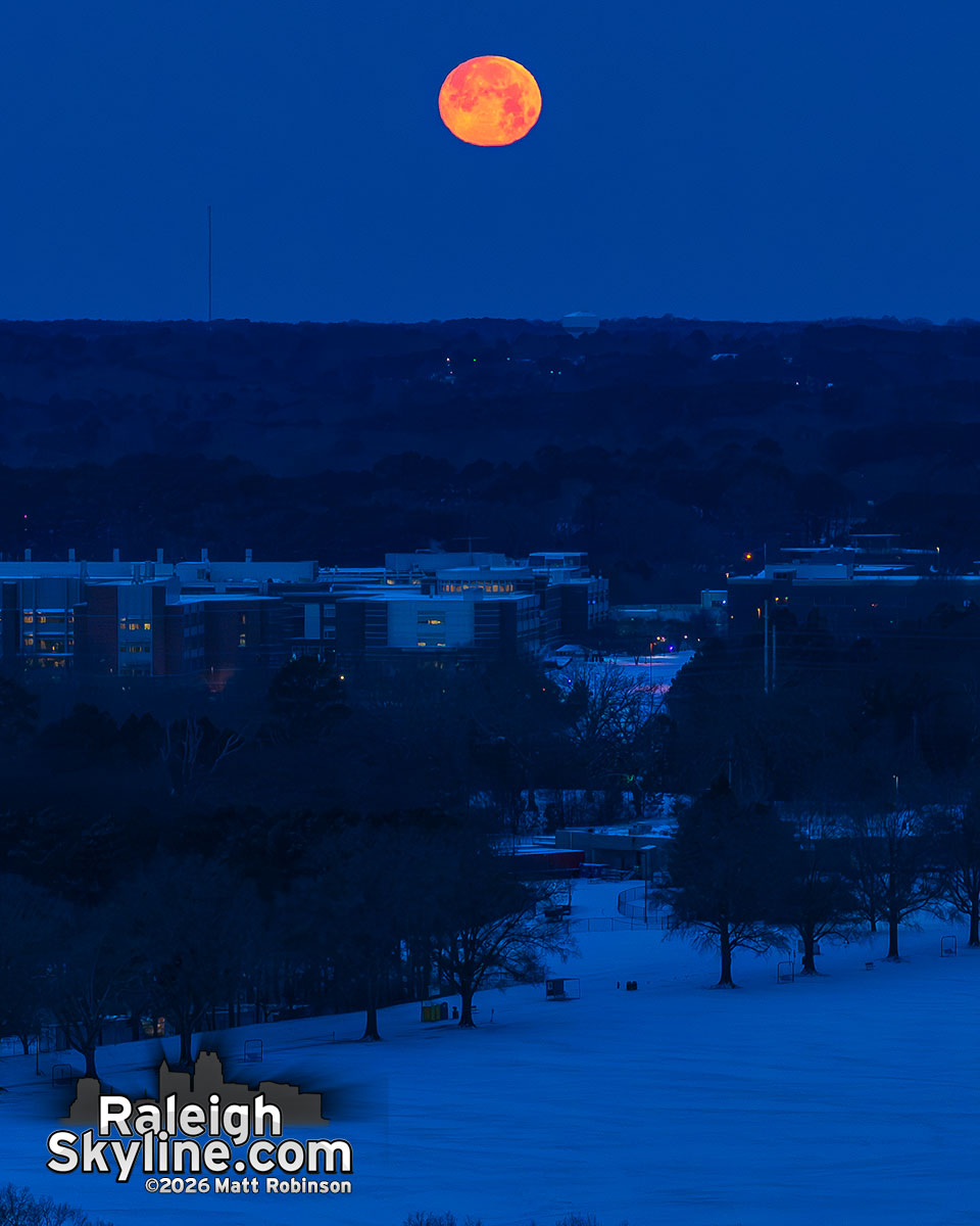 Full moon setting over the snowy Big Field at Dix Park and NCSU Centennial Campus this morning.