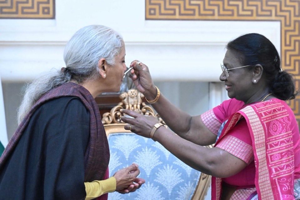 gargiuvacha's tweet photo. As a mother, a woman, and a proud Sanatani, this picture is more than just a moment, it is a statement, a powerful answer to every lie told about my Bharat and my Dharma.

For years, they have tried to convince us that our culture suppresses women, that our traditions hold us back, that our identity must be shed to succeed. But here, in this single frame, is the truth that destroys every one of those falsehoods.

A Sanatani Nari, Droupadi Murmu, a tribal woman, sits as the First Citizen of Bharat, the President of this great nation. Another Sanatani Nari, Nirmala Sitharaman, from a middle-class background, is the one handling the economy of a 1.4 billion-strong nation, navigating it through global crises. No dynastic privilege, no “empowerment” handed to them as charity, only merit, grit, and the indomitable spirit of Sanatana Dharma.

And they do it not by rejecting their identity, but by embracing it. Draped in sarees, wearing bindis, deeply rooted in our Sanskaras, they prove that true power does not come from mimicry of the West—m, it comes from standing tall in one’s own civilization.

I see Rashtra Mata Murmu feeding dahi-cheeni to Sitharaman before she presents the budget, a ritual every mother in Bharat follows before sending her child into an important battle, be it an exam or a new journey. This is not superstition; this is Sanatana Sanskriti in its purest form, tradition blending seamlessly with progress.

And as I watch this, I know what to tell my daughters. This is your Bharat. This is your Sanatana Dharma. And no matter what the world tells you, never believe that you must abandon your roots to reach your potential. This is proof that our traditions do not shackle us, they empower us. Our culture does not suppress us, it uplifts us.

For those who claim that Bharat is a land of oppression, look here. This is a country where women rise, not because of their gender, caste, or privilege, but because of their Karma and Gyaan. This is a country where a tribal girl can become President and a middle-class woman can lead its economy. Where Shakti is not a symbol, but a living force guiding the nation.

This picture is my assurance, my hope. My daughters will grow up knowing that as Sanatani Naris, they are limitless. They do not need to seek validation from the world; the world will take note of them. Because in Bharat, we do not just speak of women empowerment, we live it. And that, to me, is the greatest strength of our civilization.