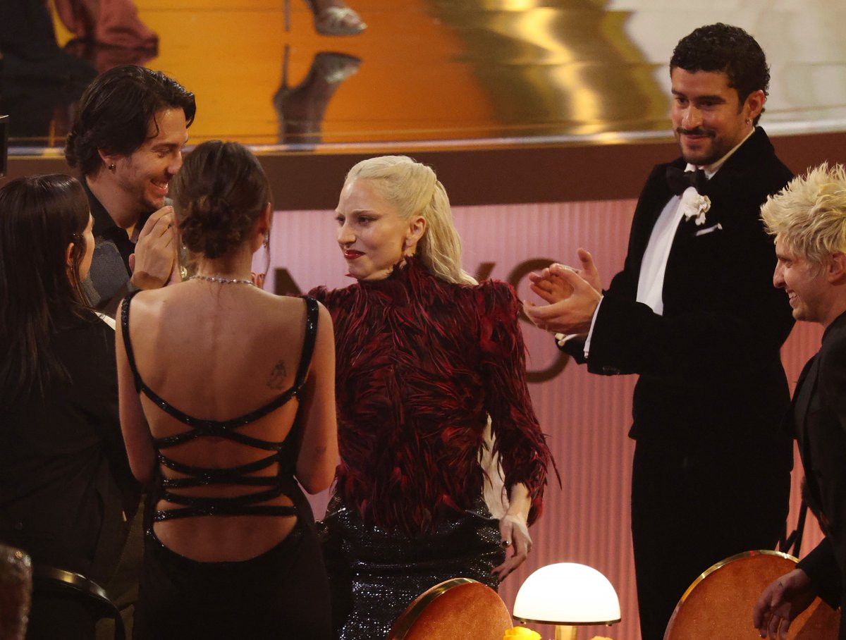 ladygaganownet's tweet image. Billie Eilish, Charlotte Lawrence, Bad Bunny, and Andrew Watt cheering for Lady Gaga’s win at the #GRAMMYs.