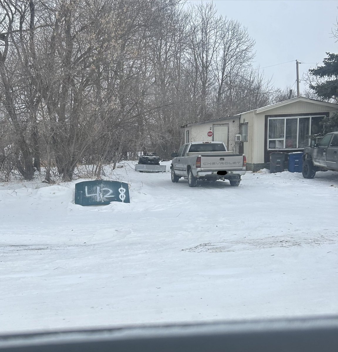You might be a redneck if you use an old vehicle hood and spray paint so the courier can find your house to deliver your Amazon packages.