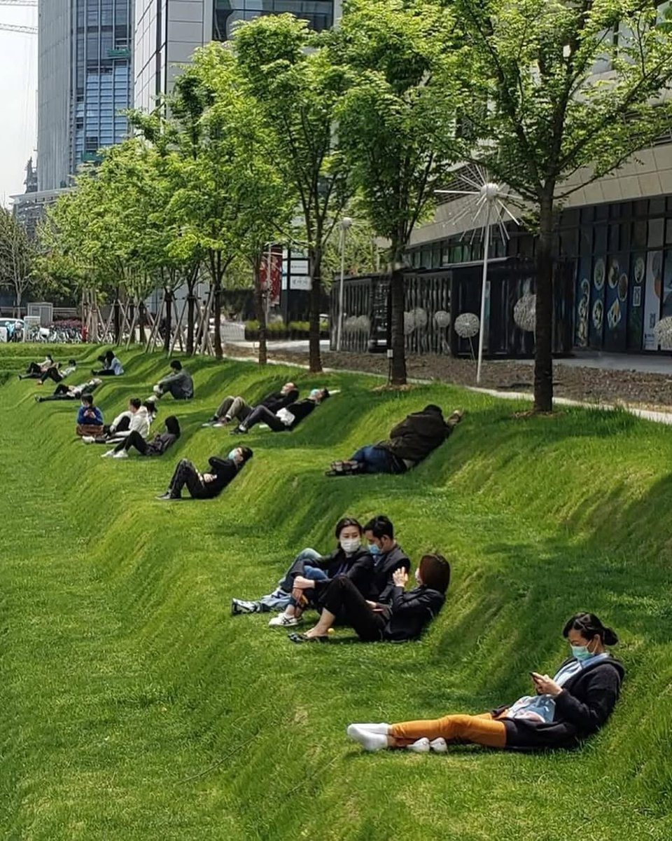hutdesigns's tweet image. In Shanghai there’s a tiered public lawn known as the Lounge Lawn, designed specifically so people can lie down, rest, or nap comfortably during short breaks in between work