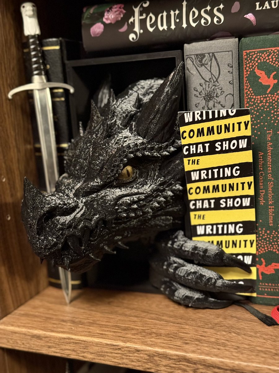 writing_show's tweet image. A fan of The WCCS sent me a picture of their AMAZING #bookshelf. And look what’s on it! Our bookmark!

Follow The Writing Community Chat Show on YouTube, Substack, TikTok, &amp;amp; Facebook! Number 3 UK writing podcast 2025 &amp;amp; number 3 to follow in 2026!

#Authors #Writing #Books