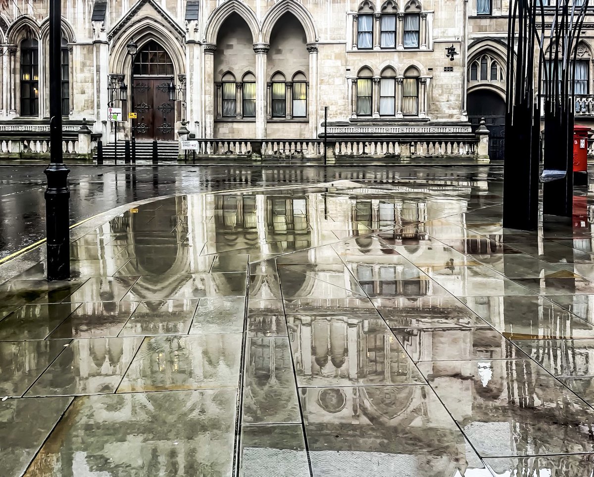 The Victorian Gothic Royal Courts of Justice, both the architecture and the incessant rain almost giving an impression of Venice, as if Carey Street had turned into a canal, and a man on a gondola was about to come floating past