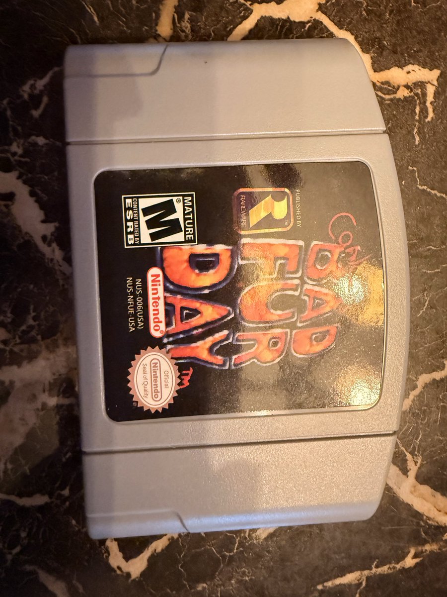 FilmgirlCybyrd's tweet photo. The evidence that it’s fake is actually very easy to see if you have any common knowledge of N64 games . First the label is new on 30+ year old game 2) the Nintendo logo circle with R is too big and 3)the back logo is glossy instead of matte 

@mercari_app it’s a fake https://t.co/u2uLBmcrNT