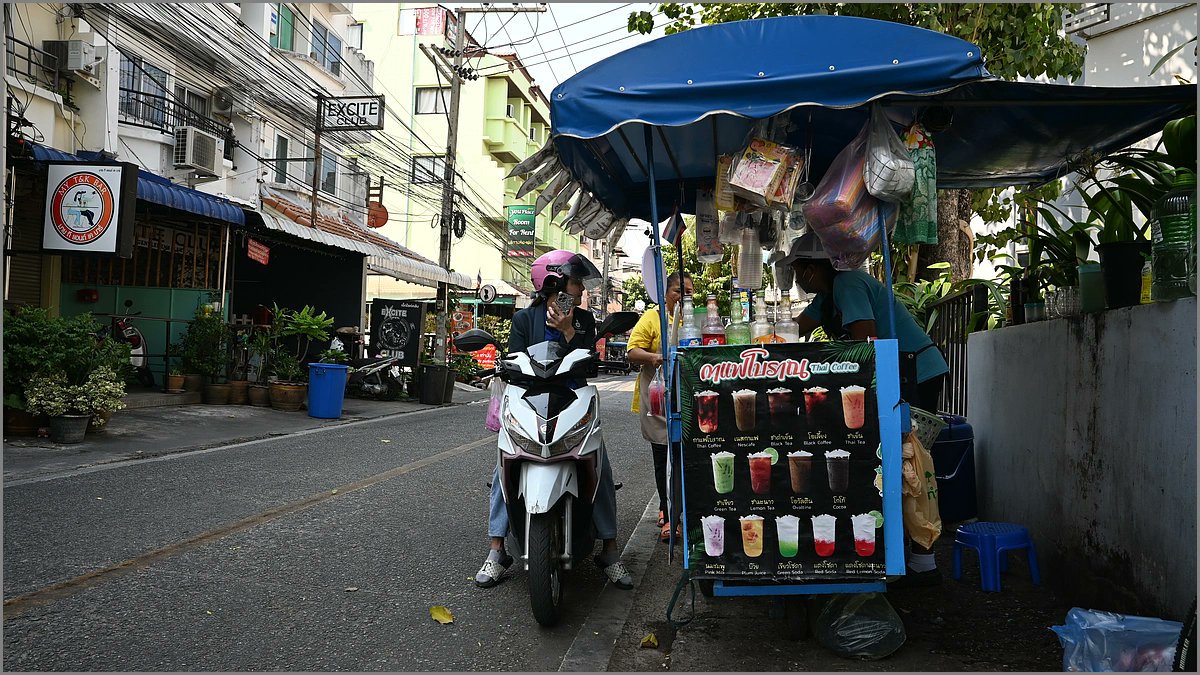 Spotted: a roadside drink stand serving vibes and life advice - scooter driver looks suspiciously committed to ordering the "I'll-survive-traffic" special. What's your go-to street drink when you need instant chill? #Thailand #Pattaya #StreetFood #Travel #Foodie #ScooterLife