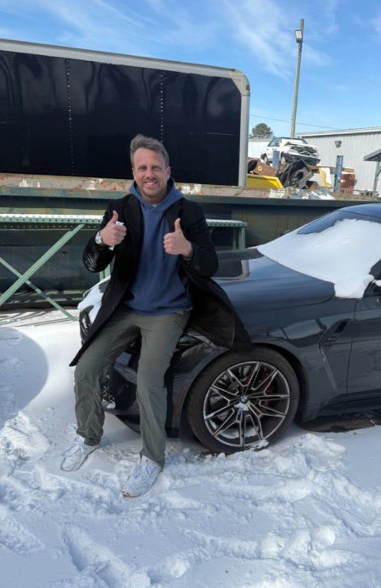 burkeanorder's tweet image. Elijah Schaffer sat on the hood of his car and posed for a photo, smiling and giving two thumbs up, on the same day he said his wife and children had been kidnapped and that the FBI was framing him for felony crimes, stealing all his money, and trying to kill him