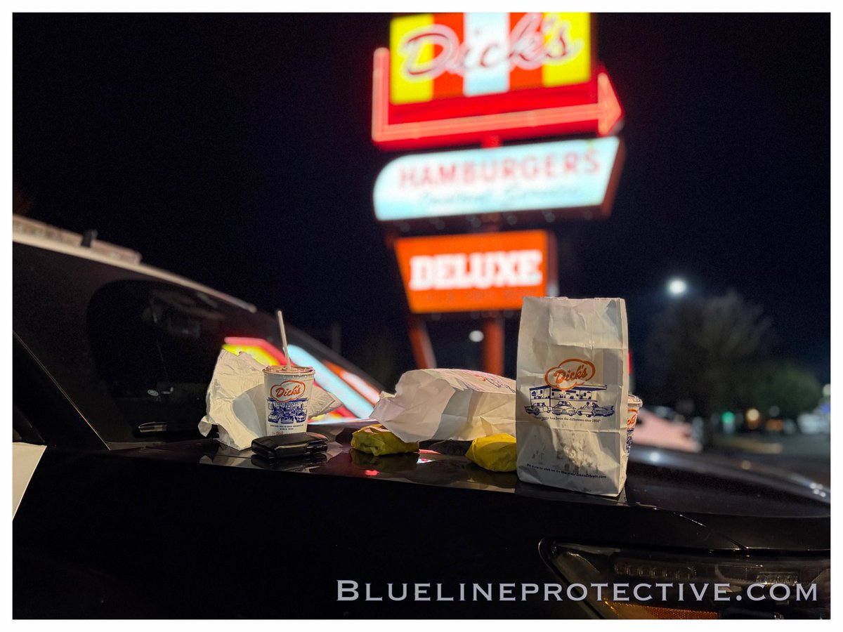 BLPSPatrol's tweet image. The patrol clock slows somewhere after midnight, when hunger sets in and neon takes over. Under the glow of the iconic sign at @DicksDriveIns a cruiser idles as paper bags hit the hood—burgers wrapped tight, fries steaming, milkshakes sweating in the cold air. #BlueLineProtective