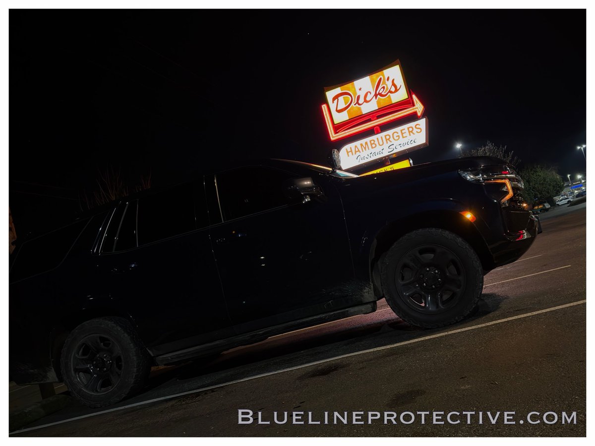 BLPSPatrol's tweet image. The patrol clock slows somewhere after midnight, when hunger sets in and neon takes over. Under the glow of the iconic sign at @DicksDriveIns a cruiser idles as paper bags hit the hood—burgers wrapped tight, fries steaming, milkshakes sweating in the cold air. #BlueLineProtective
