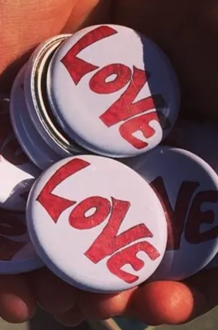 jcomey's tweet photo. @SRuhle my buddy (a big fan of yours) brought your pin to my attention. Is it related to Dave Matthews Band at all? The fanbase created LoVE pins to honor Matt Wadleigh, a fan who brought a LoVE poster to every show he went. 

So, he is curious, as am I. https://t.co/BHuvlWiKh5