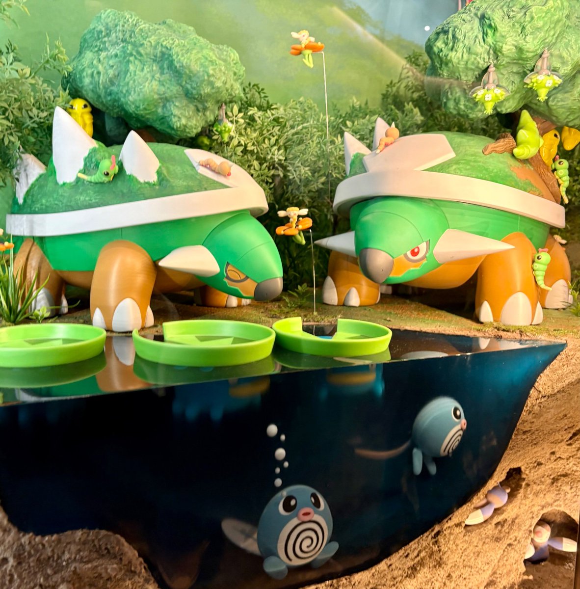 I'm such a pokemon nerd y'all cause a museum put my favourite pokemon in a display showing an amazing example of a natural symbiotic relationship 😭 the pokedex says Torterra lets small pokemon use its back for shelter while the small pokemon keep its shell healthy and clean