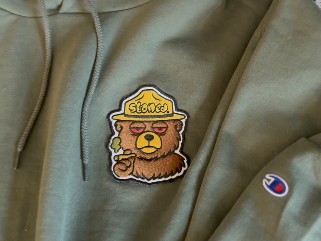 getstonedgear's tweet photo. Stoney The Bear hoodie drops 2/7/26 @ 4:20 PM CST⏰
Olive green • sewn-on Stoney patch🐻💨
First-ever Stoney on Stoned Gear🔥
Very limited🚫 #GetStoned https://t.co/Uj6eGGNk8x