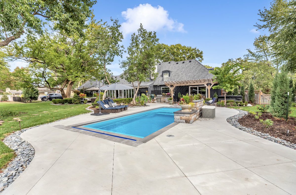 What happens when a fiberglass pool meets a fire pit, covered outdoor kitchen, and pergola? One Prairie Village backyard that’s ready for endless summer nights!