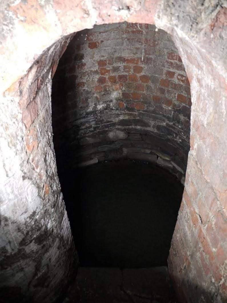 RobLooseCannon's tweet photo. There's a 1,600 year old hidden holy well in a very unexpected place! There was even a cryptic clue to its location, on a now vanished old street sign for Nassau Street. The former Irish name mysteriously said, "Sráid Thobar Phádraig".... Patrick’s Well Road.

Take a closer look near the garden of the Provost's House at the entrance to the Trinity Arts building.From the roadside, you'll see a pillar, a 1950’s crumbling concrete eyesore. Take a gander from the Trinity side, and you'll see a locked gate. Beneath that some Georgian red bricks and mysterious looking steps down to a more ancient stone basin, beneath Nassau Street itself. This is the magical mysterious Saint Patrick's Holy Well!

It was once a famous landmark and pilgrimage site. The well was even the subject of a satirical poem by the Dean of Saint Patrick’s Cathedral, Jonathon Swift. Legend says when the well dried up in 1729, Dean Swift mocked the infamous alcoholism of Trinity students, implying that in their debauchery, they'd drunk the well dry.

Centuries later, in 2009, a structural survey was performed due to worries construction of the Luas line could damage the ancient structure. It seems the only action taken was to lock up the well permanently. 

Despite the claims that St. Pats Cathedral Park is the location of the "real" holy well used by our patron saint, archaeology appears to support the ancient Nassau Street site being the primary baptismal well where the first converts in Dublin were bathed.

Ironically it's Catholic fate was tied to the pagan Vikings. The well was originally 40 feet deep, and its opening was at ground level.
But when the last vestiges of the "Thing Mote", the Viking Parliament mound, was demolished in the 17th century some of the debris was spread along what is now Nassau Street, then known as Patrick’s Well Lane. This resulted in it going partially underground and being reduced to 4ft deep. 

In a highly dubious tract in the "Life of St Patrick" from the 12th century the “fountain of St Patrick” was created by the enslaved Welshman himself, Moses style a-la smacking a rock with his magic crozier. Property deeds from 1592 mention it as a feature of the southern border “the lane that leads to St Patrick’s Well to the south of the monastery”. 

Another of the few historical mentions of the well was from an English journalist circa 1610 sardonically noted "On St Patrick’s Day the water is more holy than it is all the year after, or else the inhabitants of Dublin are more foolish upon this day than they be all the year after.” On that day, he wrote, “thither they will run by heaps, men, women and children, and there, first performing certain superstitious ceremonies, they drink of the water”.

One final bizarre and unlikely legend about the well is that frogs were introduced to Ireland when they spawned spontaneously from it, or even due to an unnamed English doctor, “a very good protestant ... to show his zeal against popery”, imported frog spawn from Liverpool and fecked it in. That'll show that pesky pontiff!

SOURCES
Gary Branigans "Ancient and Holy Wells of Ireland" (2012), The History Press 

https://t.co/WeUZ0vyTAI…

https://t.co/j88KZsSWAb…