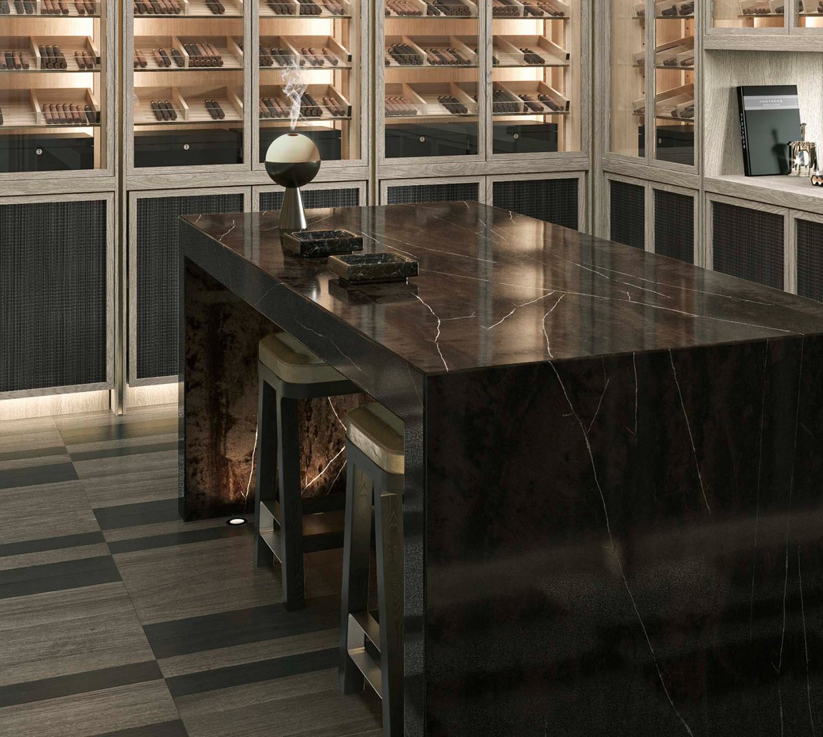 kellyhoppen's tweet image. This cigar room was designed to feel intimate and contained with the best filtration. A marble table anchors the room, and the framed “window” into the next sitting room keeps a connection without giving up privacy. #cigarroom #bespoke #luxury