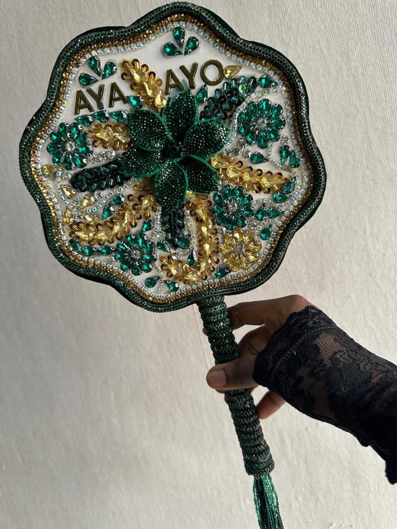 Applique hand fans. 
Weddings ✅
Parties      ✅
Photoshoots ✅    
Price ranges from 35k to 100k, depending on preference and specifications. 
Send <a href="/millinerybydebs/">Millinery by Debby|Fascinators|Handfans|Beaded cap</a>  a DM to order yours.