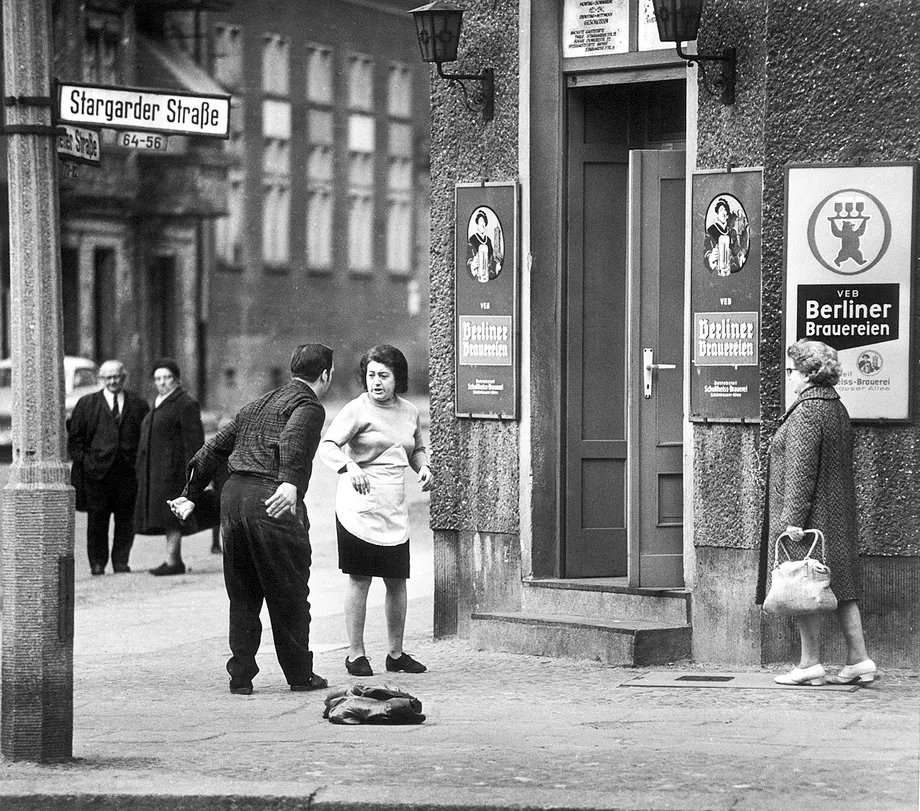 GDRvisuals's tweet photo. A man is kicked out of a bar in Prenzlauer Berg for being too drunk, East Berlin, 1974. https://t.co/LDVtAQPhpE