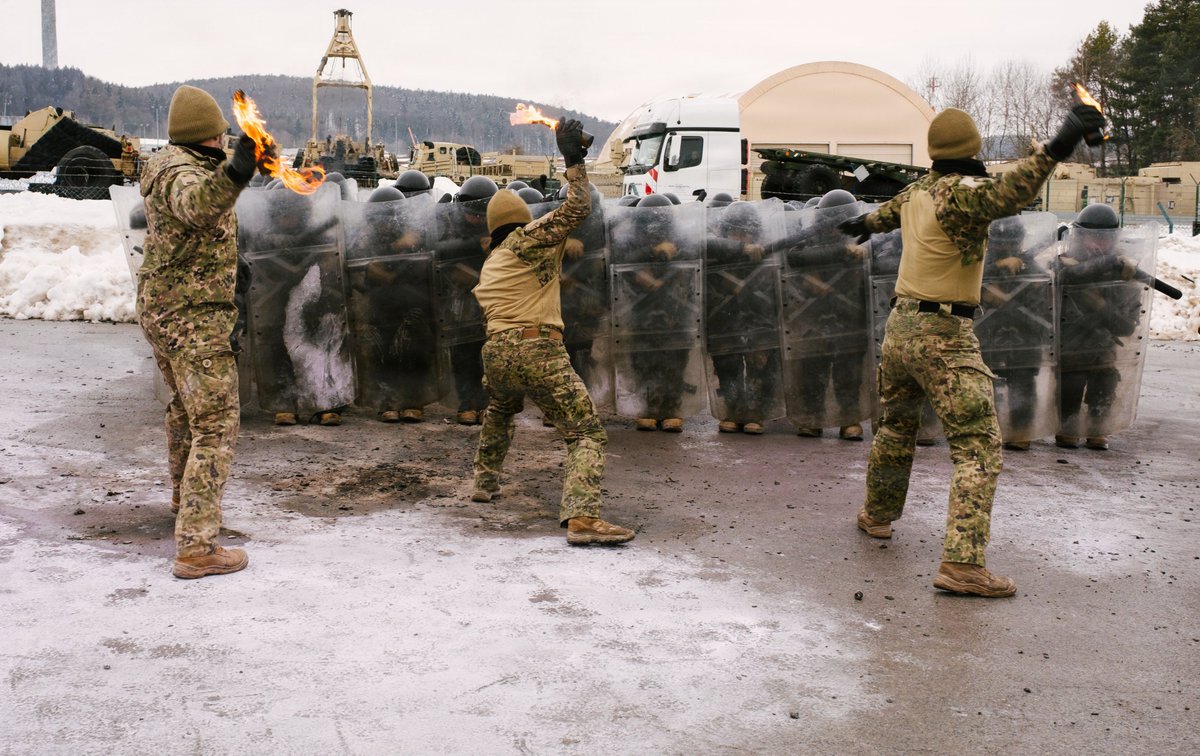 FLGuard's tweet image. Florida Army National Guardsmen assigned to Alpha Troop, 1st Squadron, 153rd Cavalry Regiment, and Portuguese Army military police with the 2nd Lancers Regiment conduct fire phobia training during a #JMRC rotation at Hohenfels Training Area, Germany, Feb. 2, 2026.