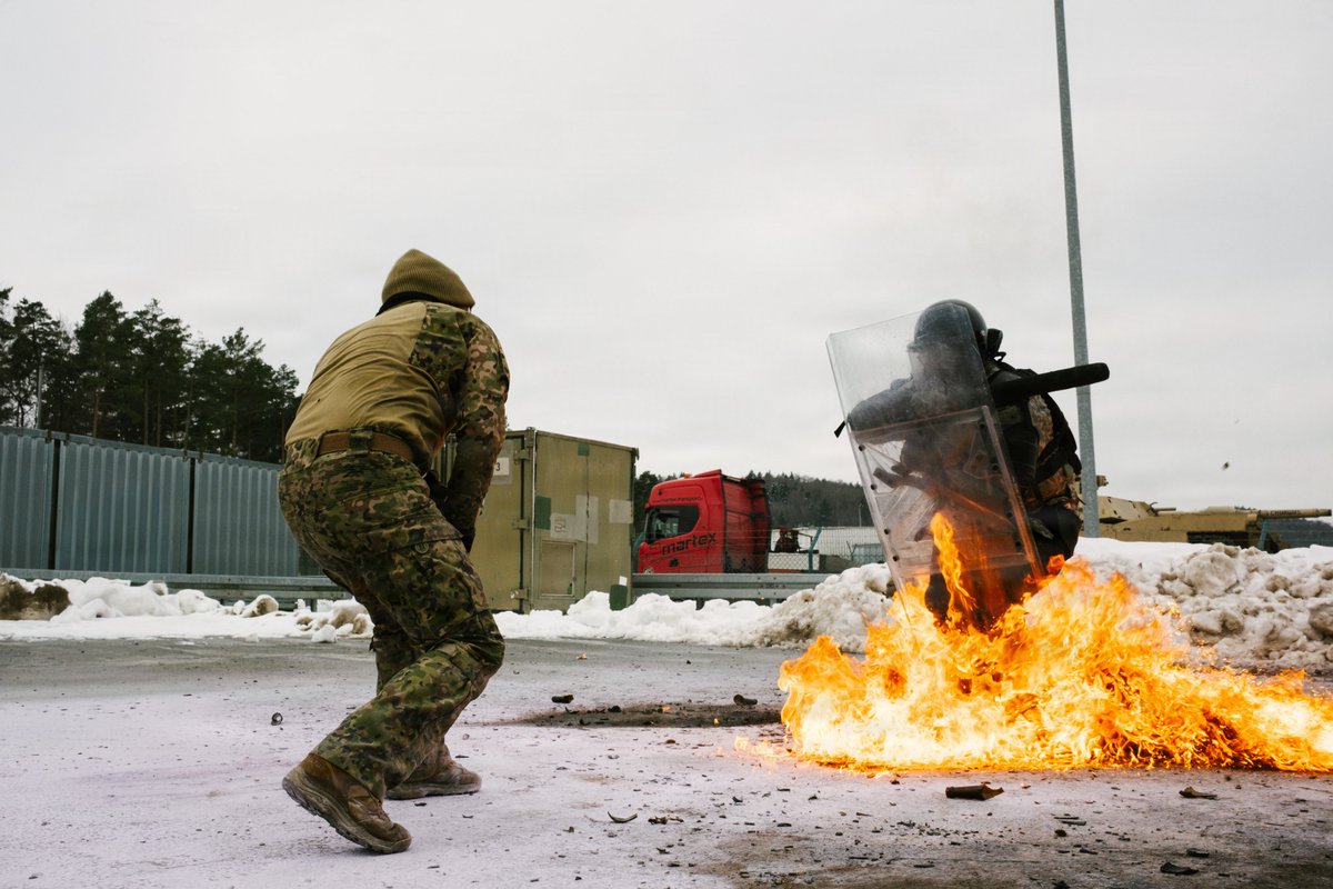 FLGuard's tweet image. Florida Army National Guardsmen assigned to Alpha Troop, 1st Squadron, 153rd Cavalry Regiment, and Portuguese Army military police with the 2nd Lancers Regiment conduct fire phobia training during a #JMRC rotation at Hohenfels Training Area, Germany, Feb. 2, 2026.