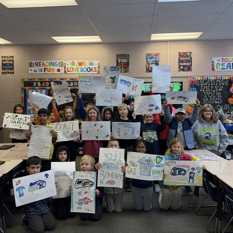 JenBindus's tweet photo. Aurora teacher Mrs. Bindus and her 3rd grade class are sending wishes to Aurora grad @_ajbarner_ and the @Seahawks for a @SuperBowl victory! "Once a Greenmen, always a Greenmen!" @DrPMilcetich @ACSD_MH @auroraathletics @GreenmenFB https://t.co/Q4eWUeD2VR