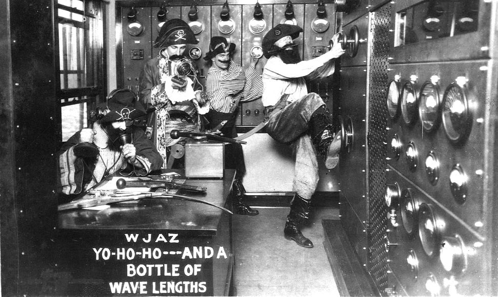 100YearsAgoLive's tweet photo. WJAZ Radio in Chicago challenges the US government’s authority to specify operating frequencies by dressing its staff as pirates and sending the subsequent photograph to Washington, DC. https://t.co/xKfDFoxPjL