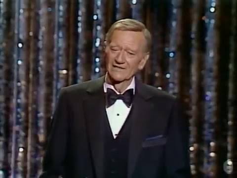 KatTheHammer1's tweet image. In 1979, John Wayne walked onto the Oscar's stage with no stomach, one lung and cancer eating at him. The audience rose in a long trembling ovation.
He stood anyway weather- beaten, unbroken.
His last public appearance became his final lesson: show up even when it hurts.