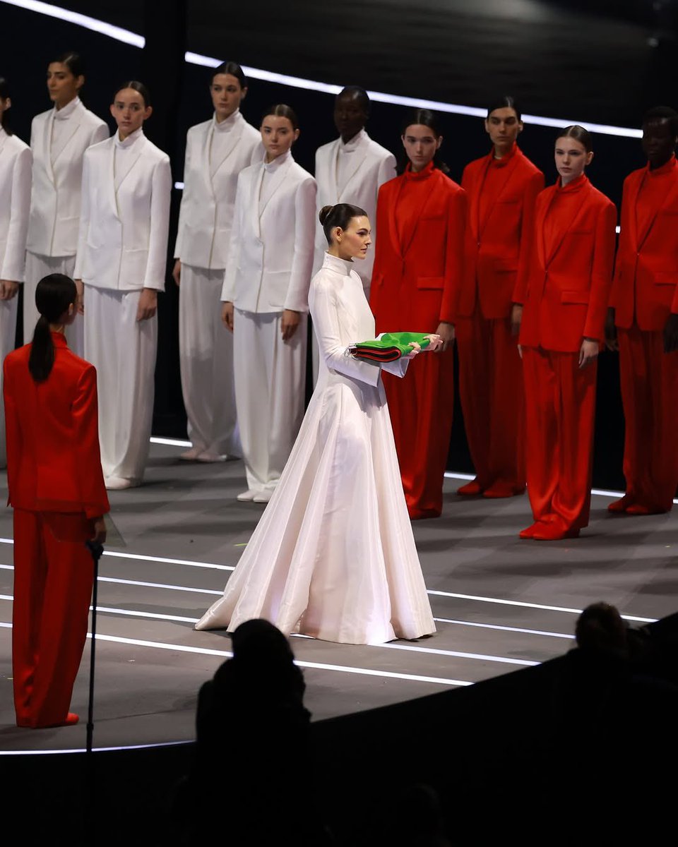 upnextdesigner's tweet photo. A tribute to Giorgio Armani. ❤️

The stadium lights up in green, white, and red as custom Armani suits take center stage. Three runways, three groups of models, one celebration of Italian elegance. Vittoria serves as the flag bearer for the opening ceremony. https://t.co/3hCgPCIEgn