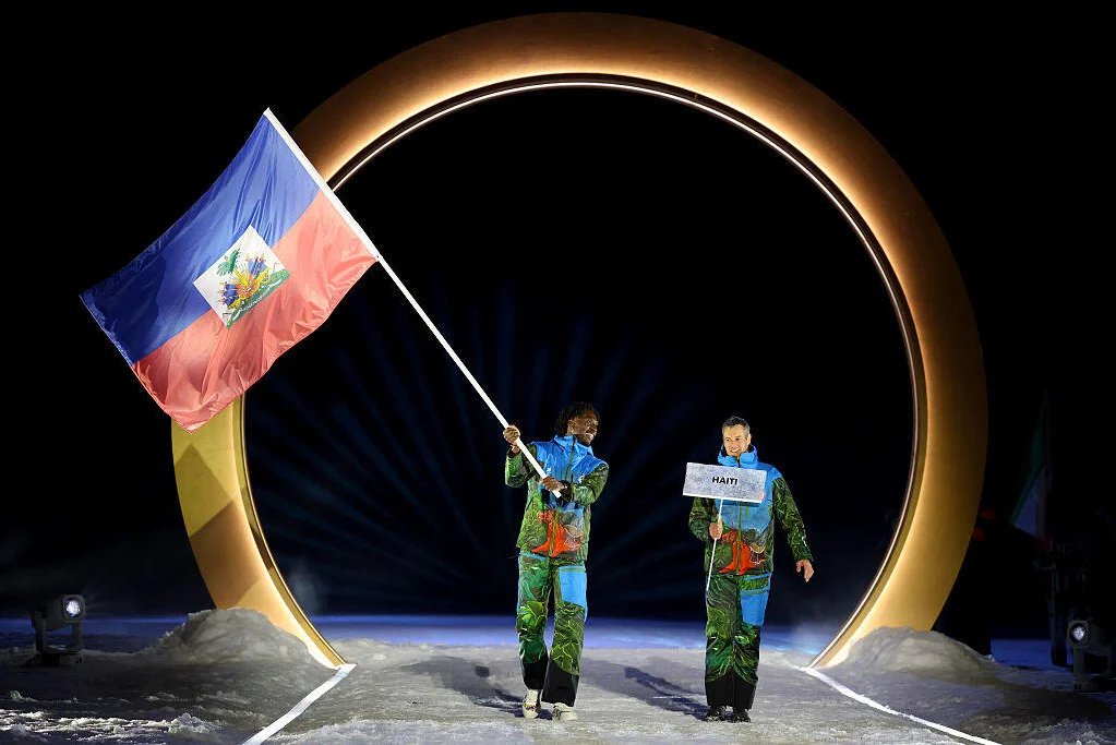 Flagbearer Stevenson Savart of Team Haiti 🇭🇹 enters with his teammate during the opening ceremony of 2026 Winter Olympic games in Milano Cortina. 

📸 Maddie Meyer / Getty Images