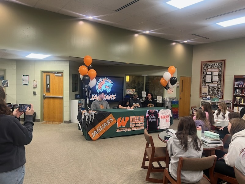WheelerHighOff's tweet photo. Congratulations to Ashlynne Trinidad. She signed her letter of intent to play softball at Governors State University today. Go Bearcats! https://t.co/rnCR00Jte2