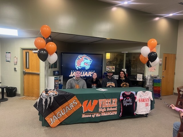 WheelerHighOff's tweet photo. Congratulations to Ashlynne Trinidad. She signed her letter of intent to play softball at Governors State University today. Go Bearcats! https://t.co/rnCR00Jte2