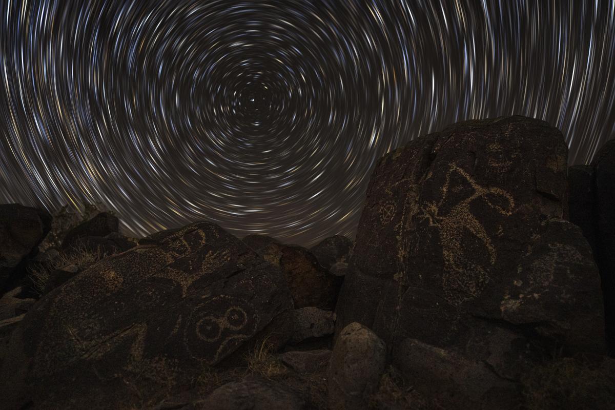 “The photograph is about that continuity—stories carved in stone and stories written in the sky, meeting in the same quiet winter darkness,” says Grayson Kemp, of his Nightscapes photo.  zurl.co/epsOP