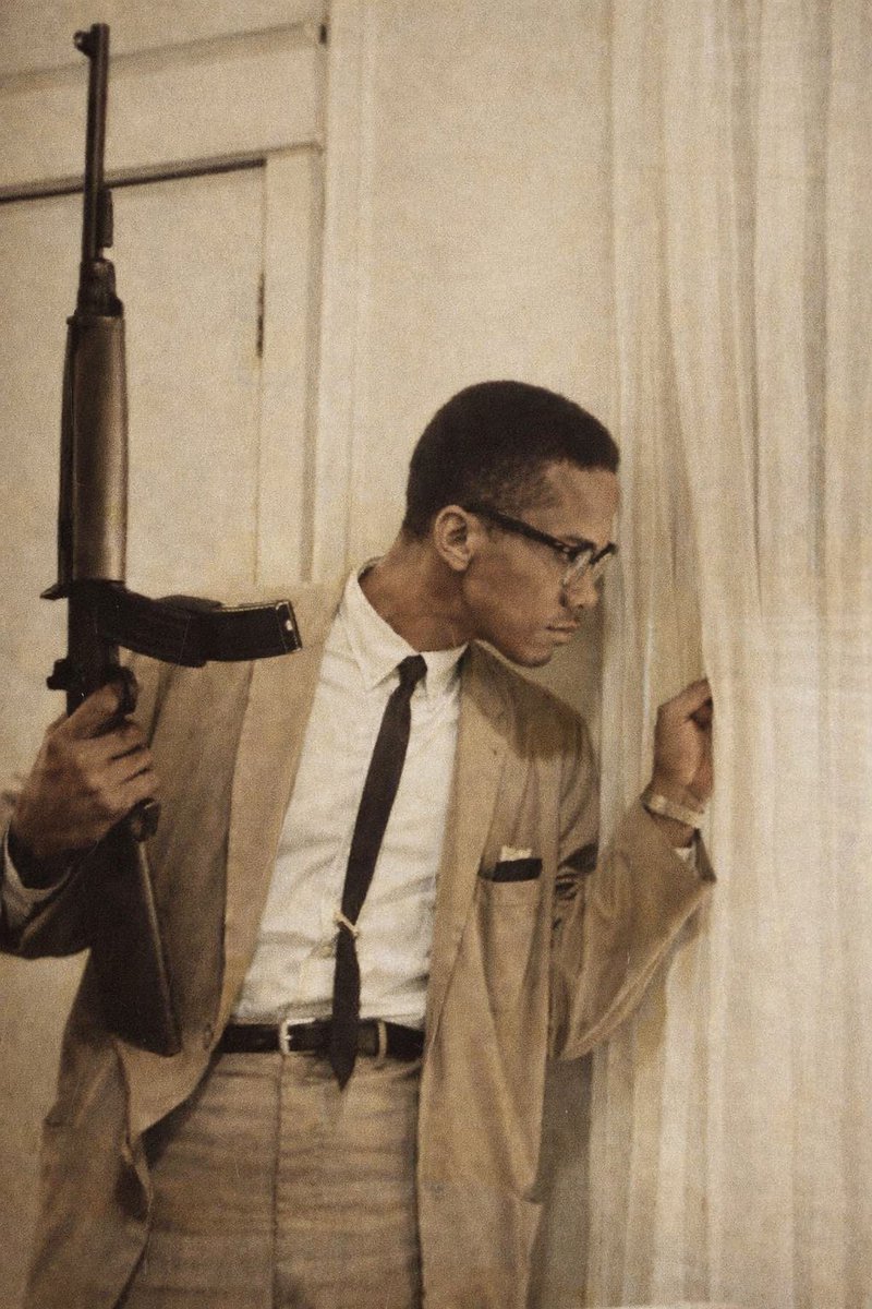 BlackMediaHub's tweet image. Malcolm X holding a Rifle while guarding his family, 1964.