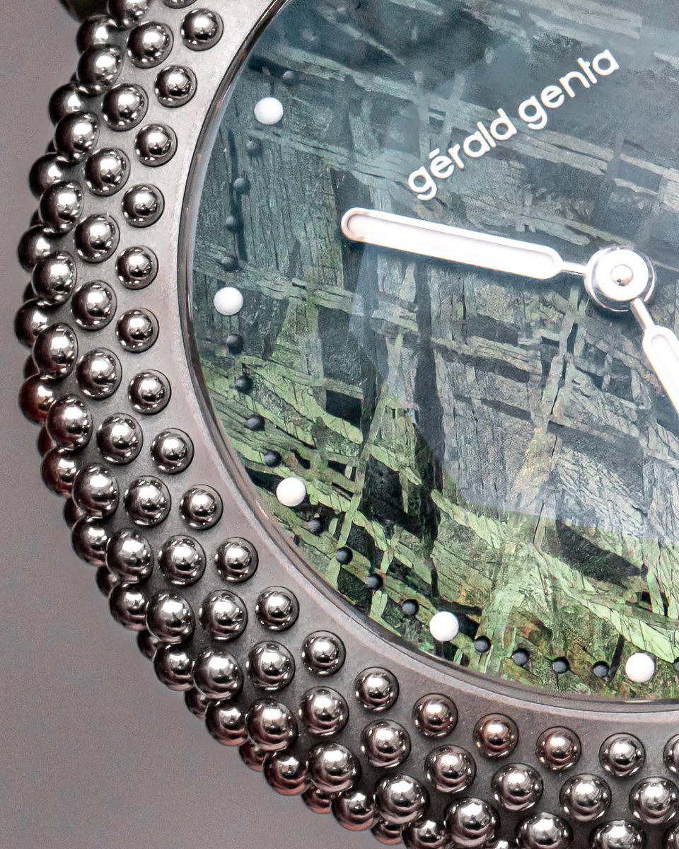 clockedby's tweet photo. @DubaiWatchWeek The Genta Gentissima Oursin in a bigger 41mm case done in titanium with exactly 241 white gold beads. These new ones are in a blue or green meteorite dial and what might look like glare is actually the octagonal faceting on the sapphire crystal. https://t.co/UDk5QVLFKW