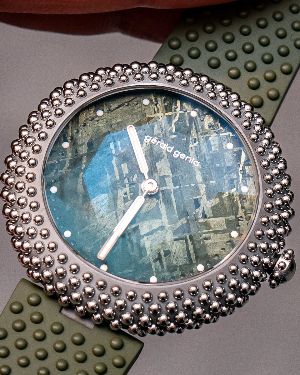 clockedby's tweet photo. @DubaiWatchWeek The Genta Gentissima Oursin in a bigger 41mm case done in titanium with exactly 241 white gold beads. These new ones are in a blue or green meteorite dial and what might look like glare is actually the octagonal faceting on the sapphire crystal. https://t.co/UDk5QVLFKW