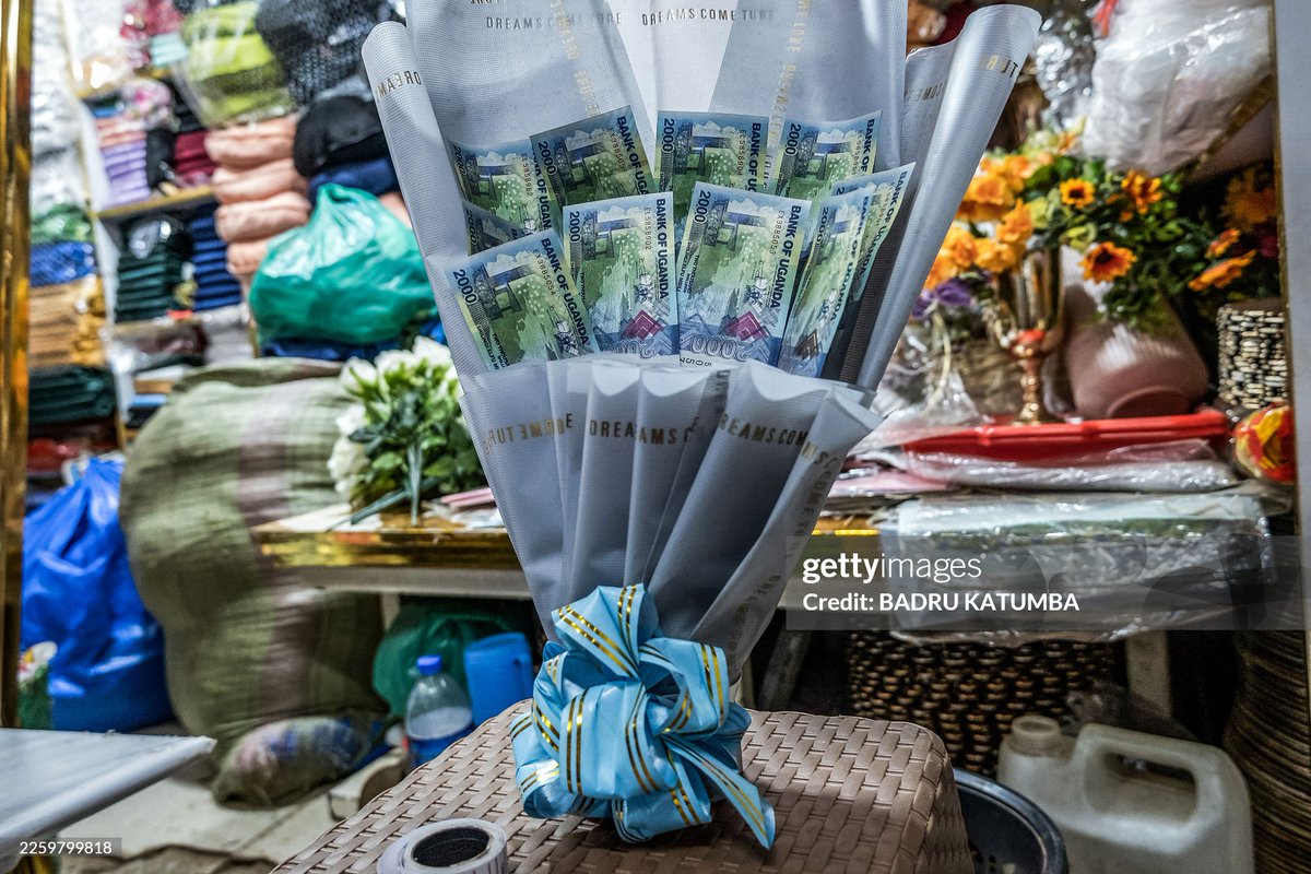 Katumbabadru1's tweet photo. A woman reacts as she receives a bouquet made of banknotes and flowers from her friend as a surprise ahead of Valentine's Day during a hangout in Kampala on February 7, 2026. Kenya, Uganda and Rwanda have issued coordinated warnings against the growing trend of "money bouquets" https://t.co/iVk9TFmfSa