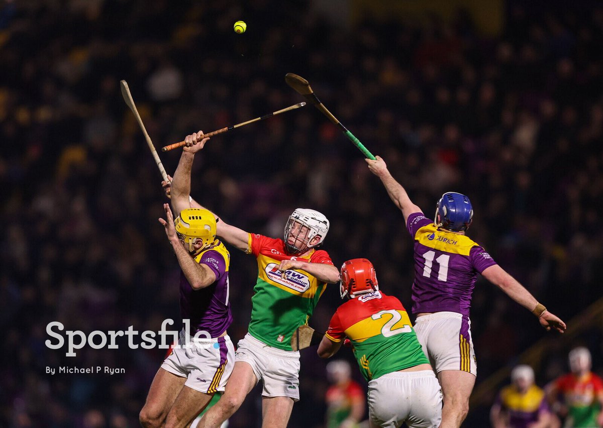 sportsfile's tweet image. Wexford players Tomás Kinsella, left, and Kevin Foley battle for possession with Kevin McDonald, centre, and Niall Bolger of Carlow during the Allianz Hurling League Division 1B match at Chadwicks Wexford Park.

📸 @ryanmilestone 

sportsfile.com/more-images/77…