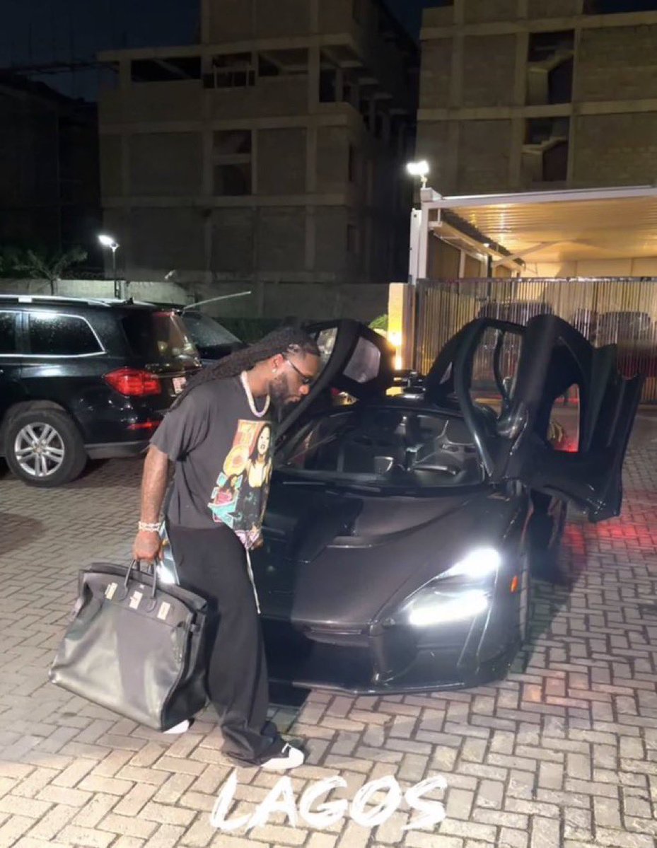 Baloxxd's tweet image. Burnaboy with one of his many toys - Mc laren worth $2M