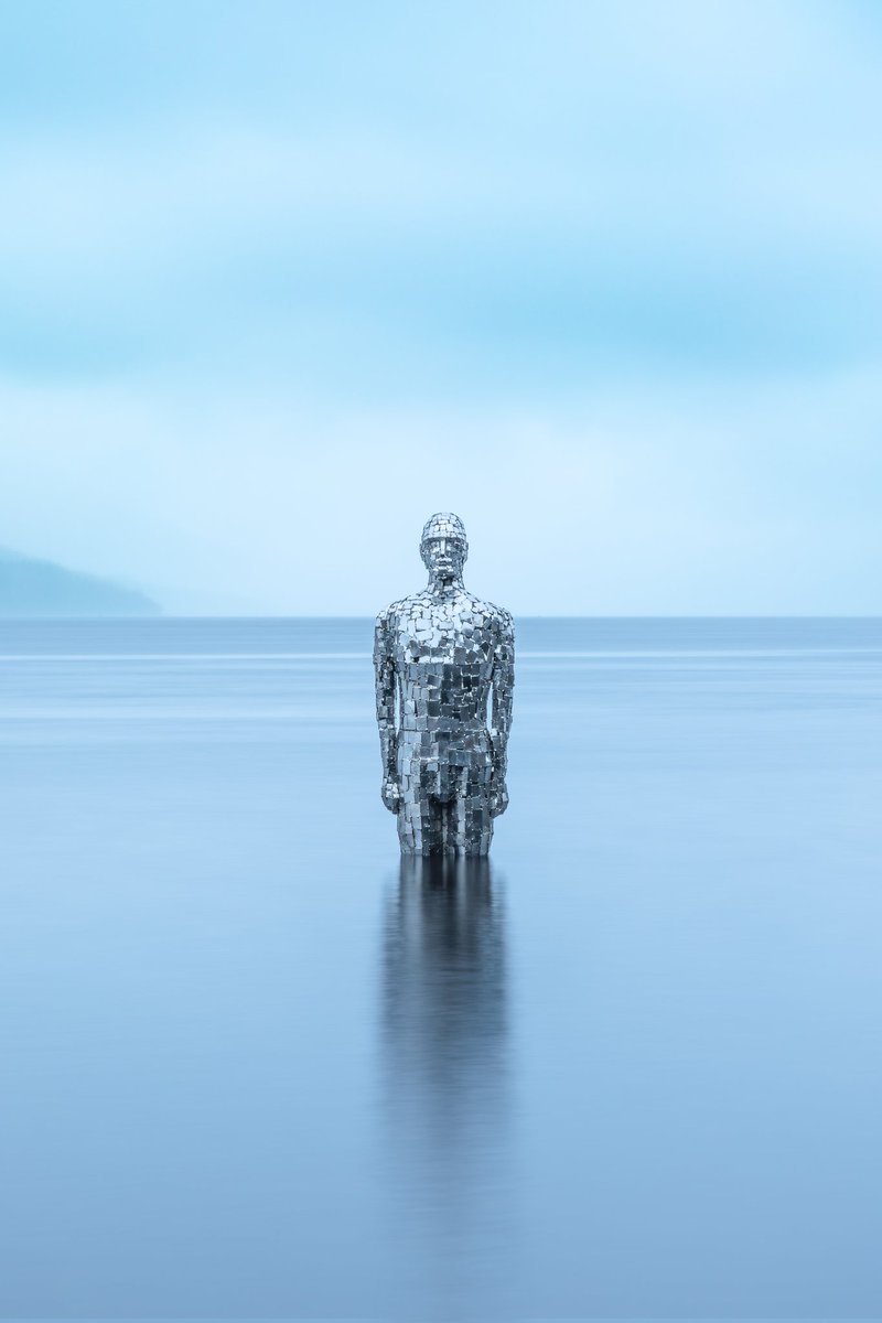 Philmcphotos's tweet photo. "Still," also known as the Mirror Man, is a 2.7-meter-tall, mirrored stainless steel sculpture by artist Rob Mulholland, located in Loch Earn near St Fillans, Scotland #longexposure_shots #visitscotlandfeature #visitscotland #canonr6markii #kfconcept https://t.co/LlTFv30JPB